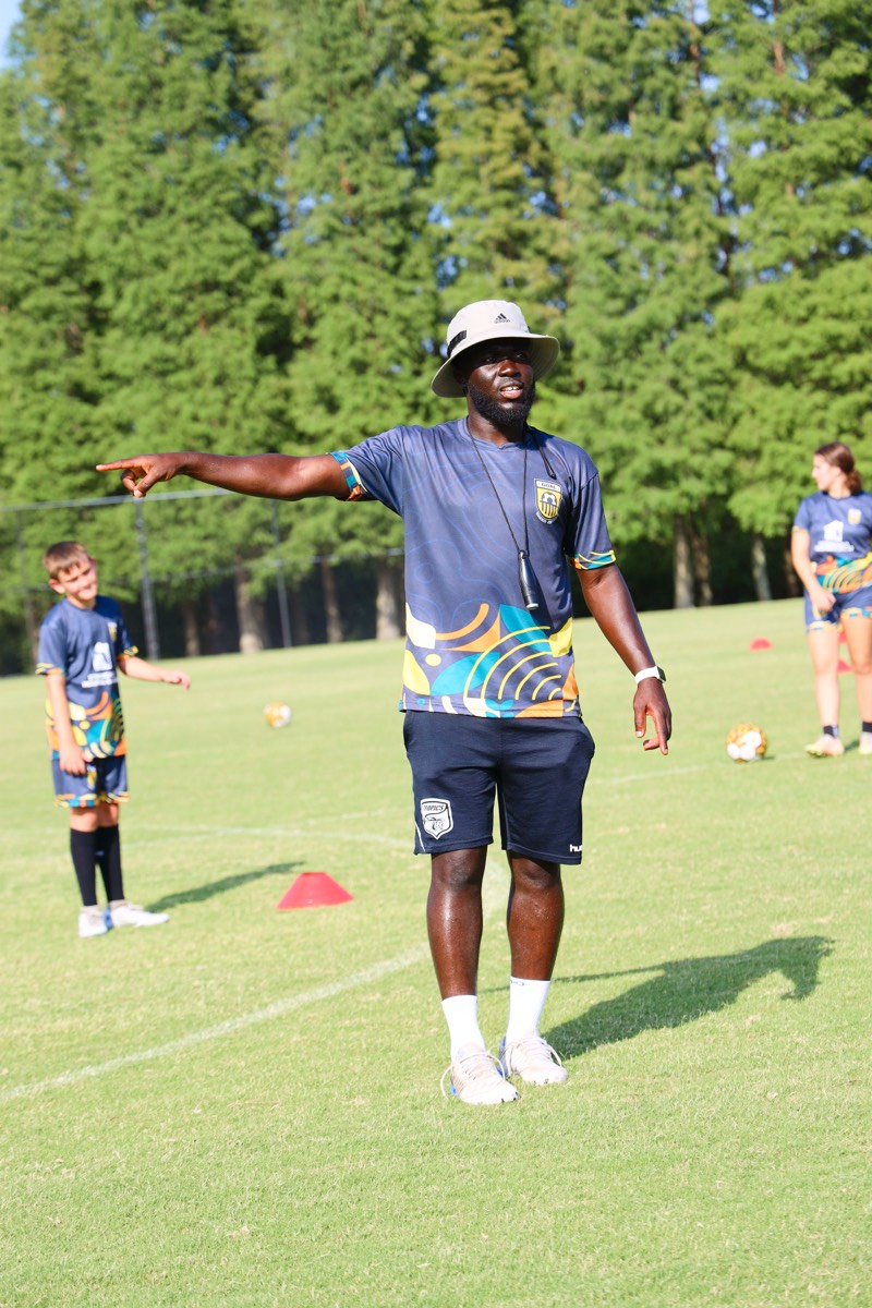 Coach Melvin directing players during training