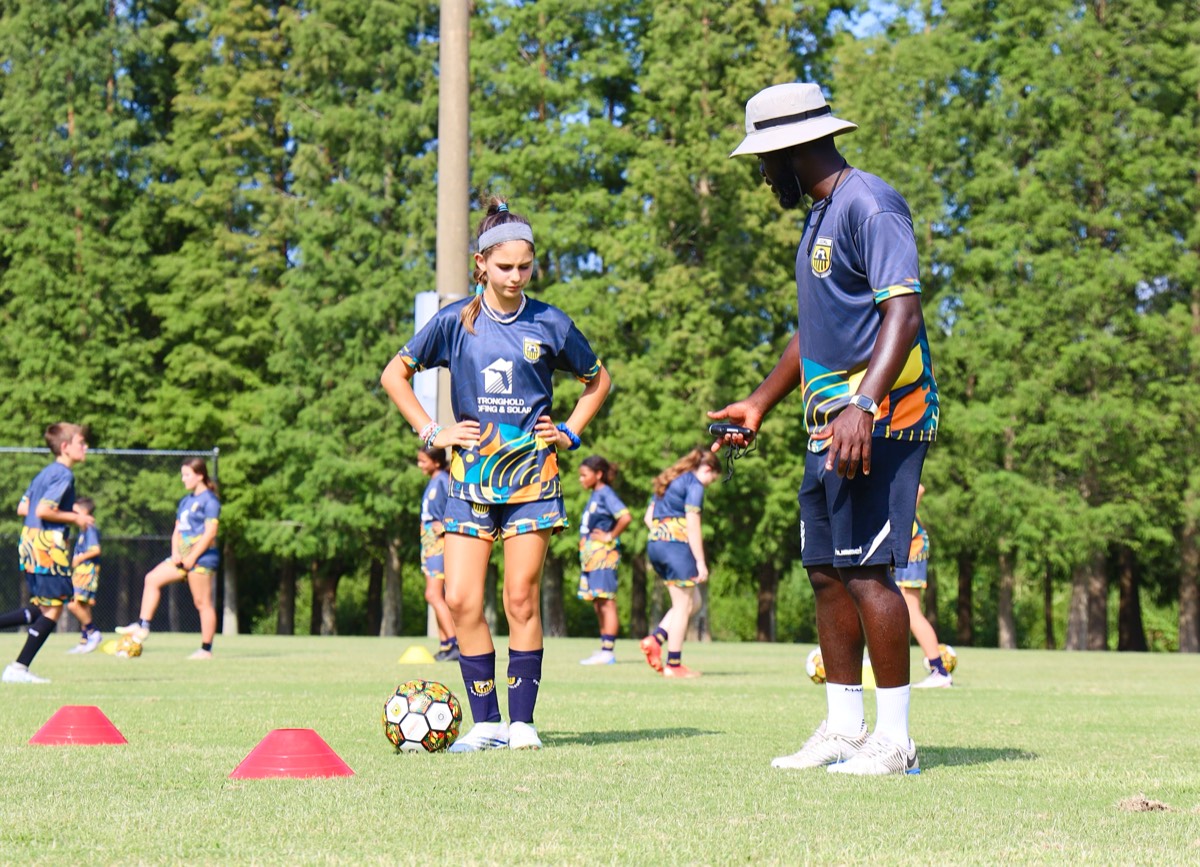Player working on ball control with Coach Melvin