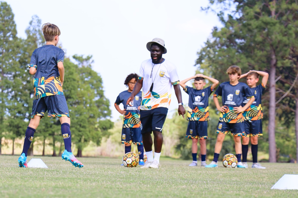 Coach Melvin leading a group drill session