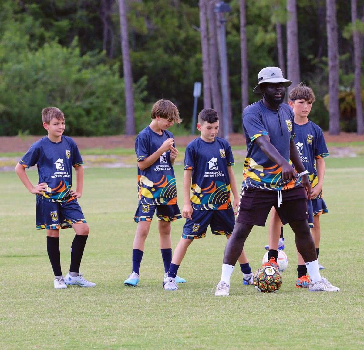 Coach Melvin demonstrating technique to players