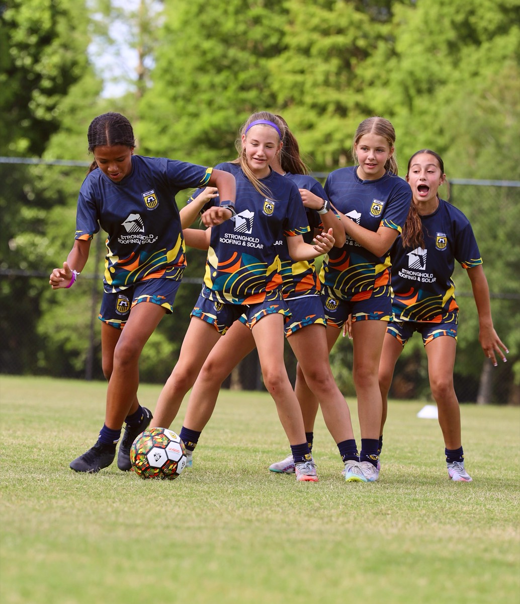 Girls competing for the ball during training